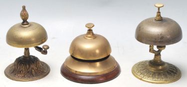 A group of three 20th century antique brass desk top ring bells having the typical dome top,