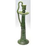 A vintage retro 20th Century studio art pottery green glazed candlestick holder having a round