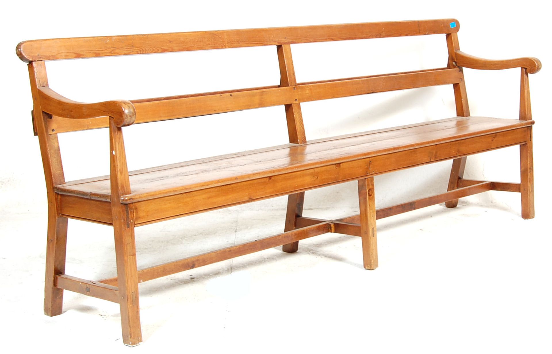 An early 20th century Railway / bus station pew bench with scroll armrest, plank seat, bentwood
