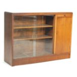 A vintage retro 20th century oak bookcase cabinet with twin glass sliding doors and adjustable