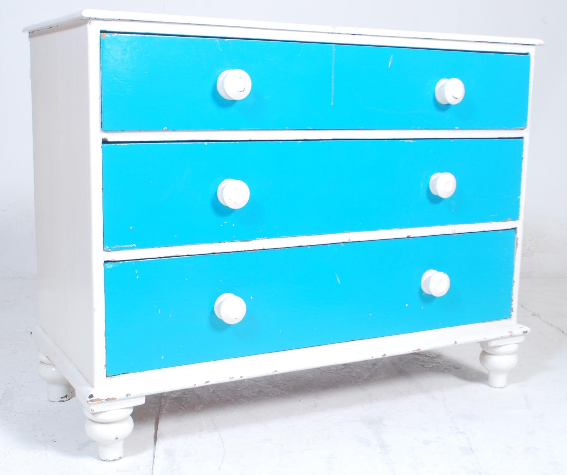 A Victorian 19th century shabby chic two tone coloured painted pine chest of drawers having a