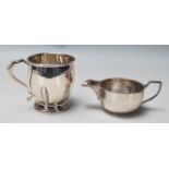 Pa pair of English silver hallmarked creamer jugs. One with circular pedestal base and Art Deco