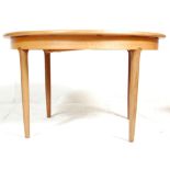 Meredew - British modern design. A 1970's retro vintage teak wood oval extending dining table raised