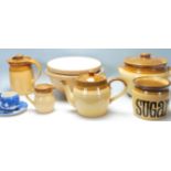 A collection of retro vintage mid century kitchenalia to include a ceramic kettle, jug, sugarpot,