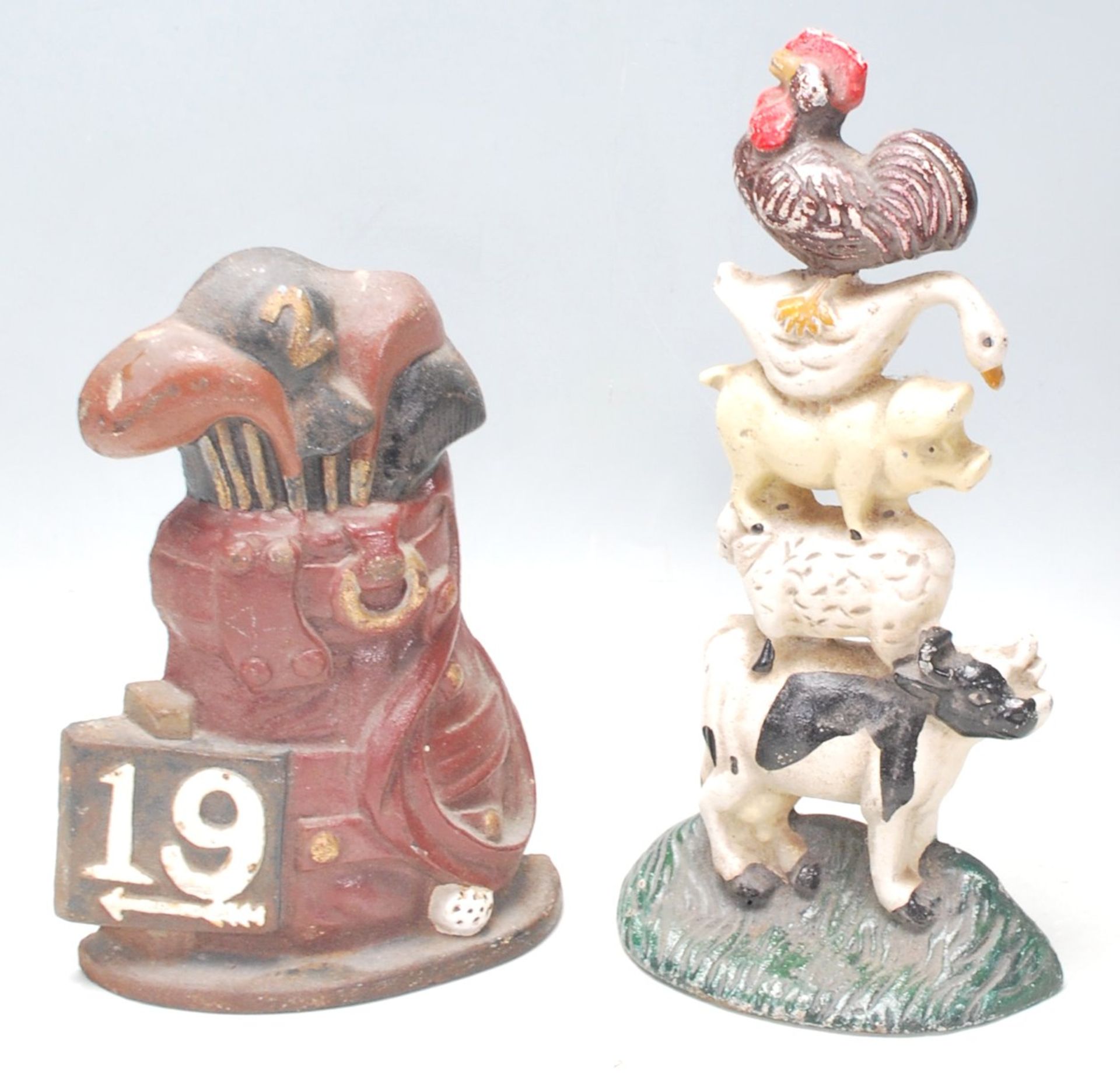 A pair of vintage mid 20th century cast iron polychrome doorstops, one in the form of golf bag