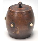An early 19th Century tea caddy in a shape of a barrel with bone studs to the front and lead.