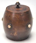 An early 19th Century tea caddy in a shape of a barrel with bone studs to the front and lead.