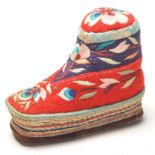 A 20th Century Chinese folk art pin cushion in the form of a shoe having embroidered floral