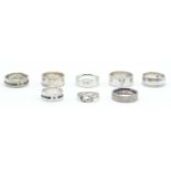 A group of eight silver rings to include mostly wide band rings including two set with square cut