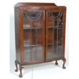 A 1930's Art Deco oak bow front library  bookcase cabinet. The cabinet having a raised back over