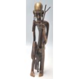 A vintage 20th Century Polynesian / Aboriginal bronze figure of a tribal elder with large earrings