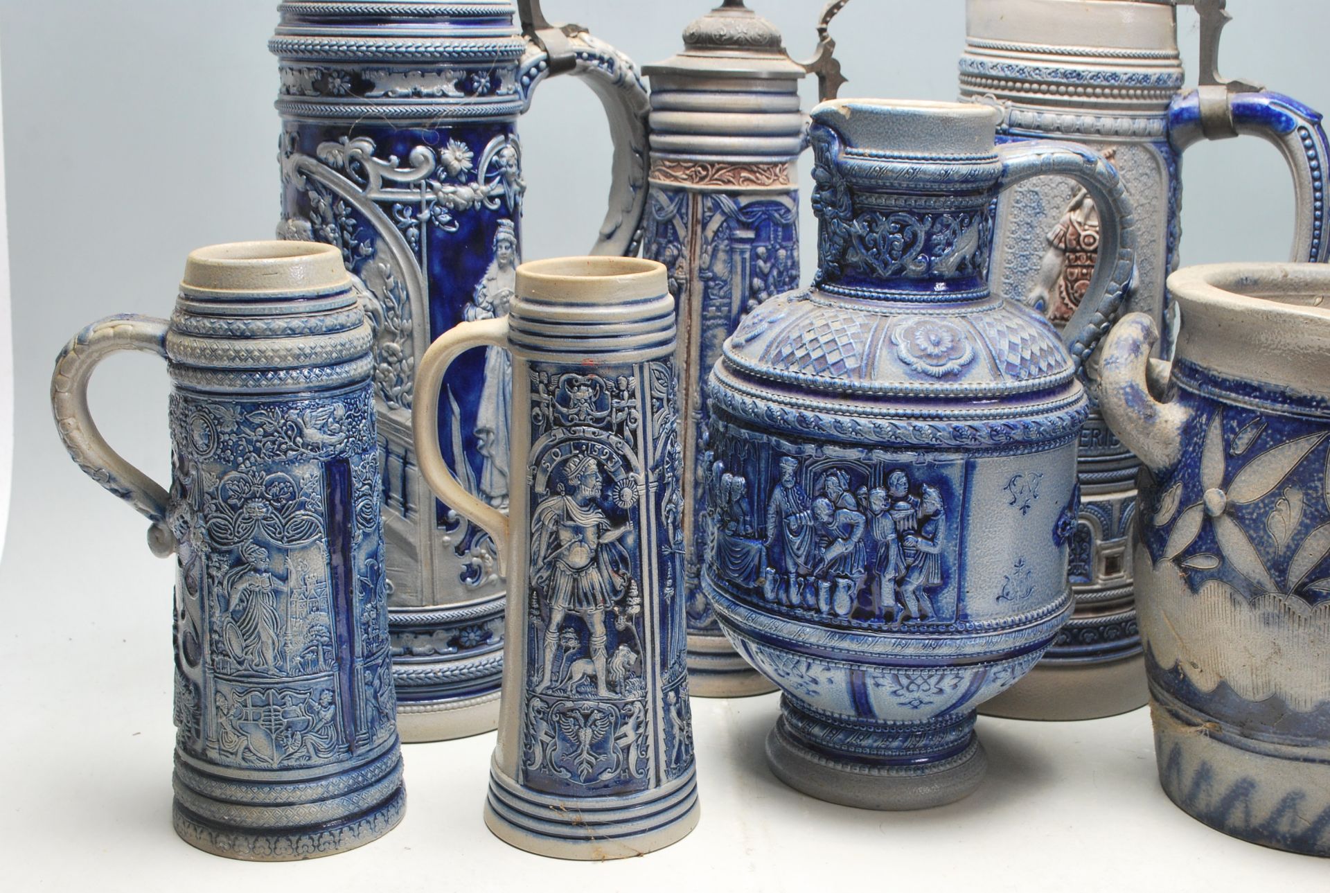A collection of 20th Century German ceramic stein drinking glasses, each having raised decoration to - Bild 4 aus 7