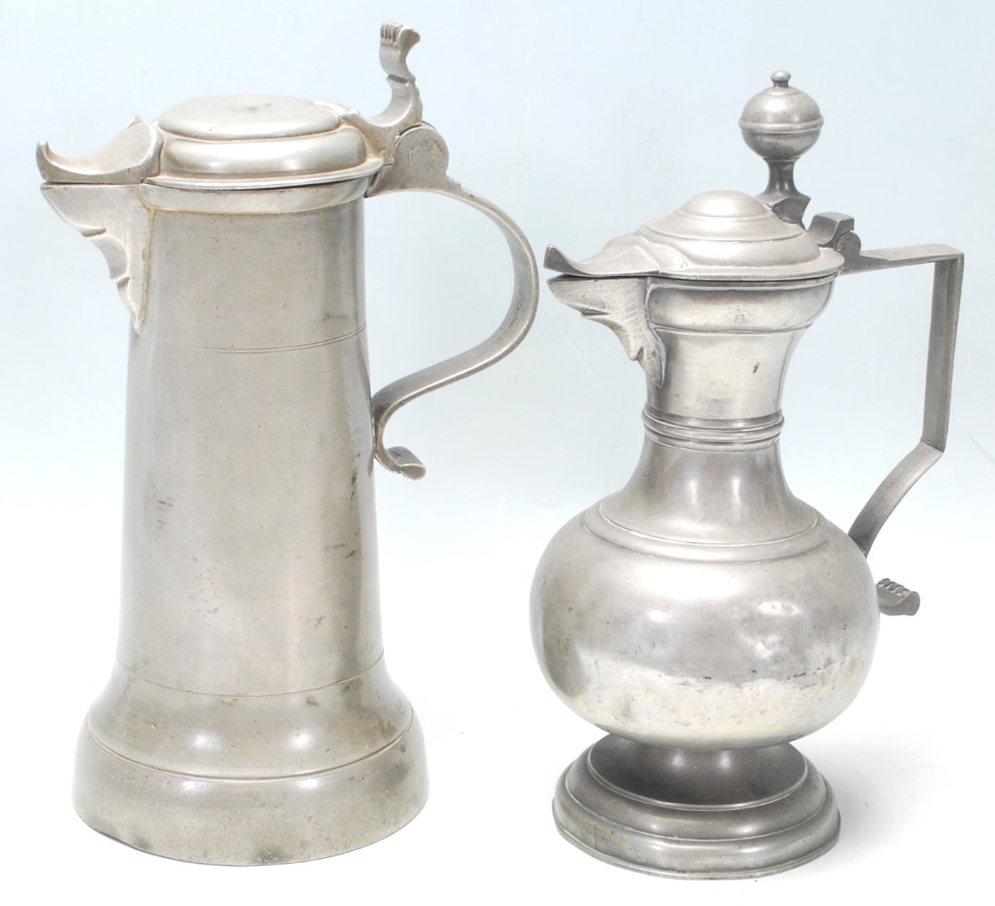 Two 18th Century pewter wine tankards having scroll handles and beak shaped spout with makers mark