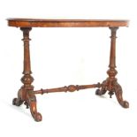 An antique 19th Century Victorian figured walnut writing table desk. The oval top with inlaid border