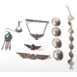 A selection of silver and silver white metal Native American Navajo jewellery to include a medallion