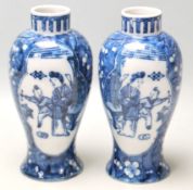 A true pair of 20th Century Chinese Kangxi vases of baluster form with decorated with plum