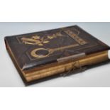 A Victorian 19th Century leather bound and gilt tooled musical photographic album with the songs
