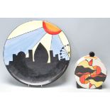 Lorna Bailey ceramic charger plate being hand painted with black, blue, yellow and orange colours,