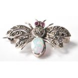 A stamped .925 silver and marcasite ladies brooch in the form of an insect with an opal set within