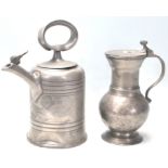An 18th Century German pewter vessel / tankard having bulbous form with scroll handle sitting on