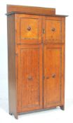 A good 1920's Arts & Crafts golden oak  small proportion oak bookcase cabinet. The cabinet with twin