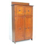 A good 1920's Arts & Crafts golden oak  small proportion oak bookcase cabinet. The cabinet with twin