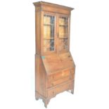 A 1920's Arts & Crafts oak bureau bookcase. The twin door bookcase having astragal glazed doors atop