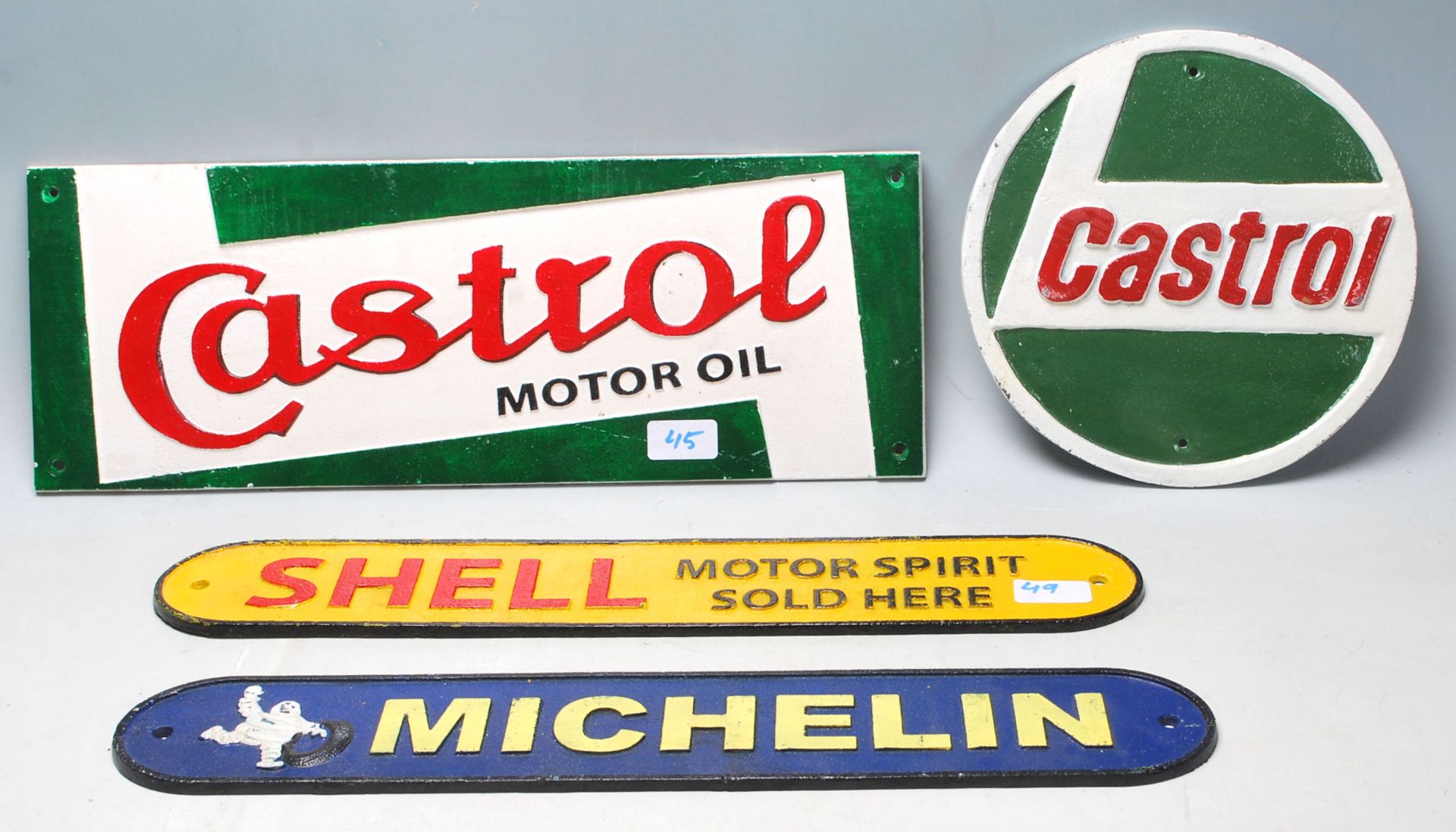 A collection of four 20th Century vintage style cast iron motoring related shop display / point of