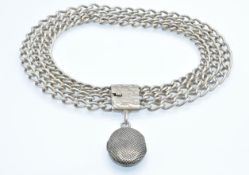 A silver locket choker necklace. The necklace strung with a silver niello chequer decorated