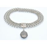 A silver locket choker necklace. The necklace strung with a silver niello chequer decorated