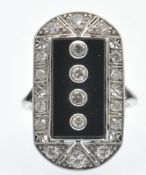 A platinum onyx and diamond plaque ring. The ring set with four round brilliant cut diamonds