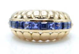 14ct gold and sapphire dome ring. The ring set with square cut panel of sapphires