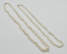 Two  9ct gold and cultured pearl necklaces. The necklaces strung with cultured pearls united by