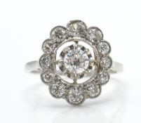 An 18ct white gold and diamond cluster ring. The r