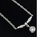 A 14ct white gold and diamond pendant necklace.Est