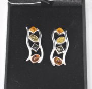 A pair of stamped sterling silver earrings set wit