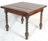 An early 20th Century oak drawer leaf dining table