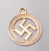 A hallmarked 9ct yellow gold swastika pendant in a