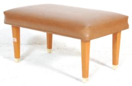 A retro 20th Century foot stool raised on square t