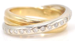An 18 ct mixed gold diamond set crossover ring. We