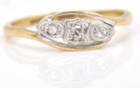 A yellow gold 3 diamond crossover ring. Size 7.N.