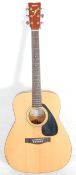 A Yamaha six string acoustic guitar model FG - 403