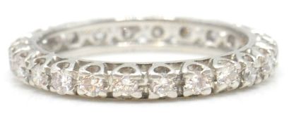 A white gold and diamond eternity ring. The ring w