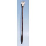 A 19th Century Victorian back scratcher having a c