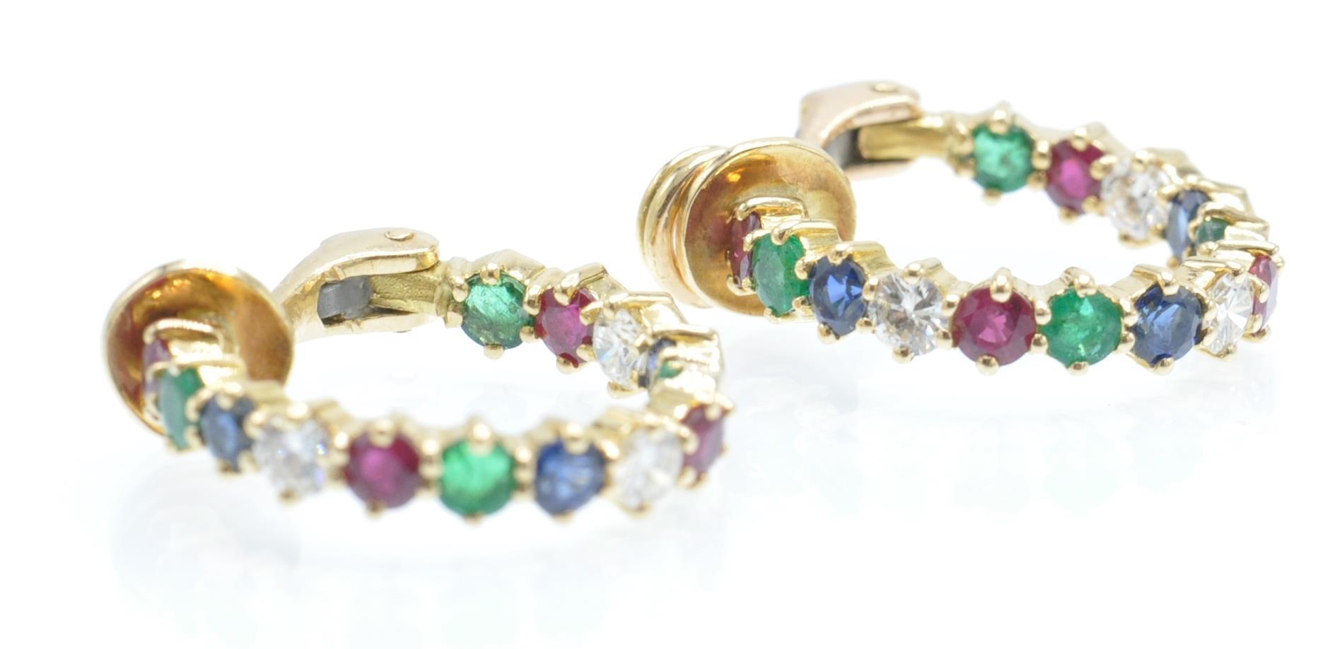 A pair of 18ct gold diamond, sapphire,  ruby and emerald earrings. The earrings with set with