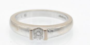 A hallmarked 18ct white gold and diamond solitaire ring. The ring set with a round brilliant cut