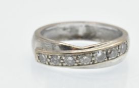 A white gold and diamond crossover band ring