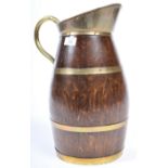 A 19TH CENTURY GEORGIAN OAK AND BRASS CIDER PITCHER EWER