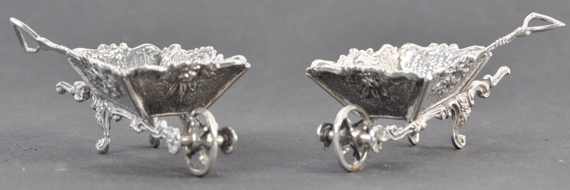 PAIR OF EDWARDIAN NOVELTY SILVER TABLE SALTS IN THE FORM OF WHEELBARROWS