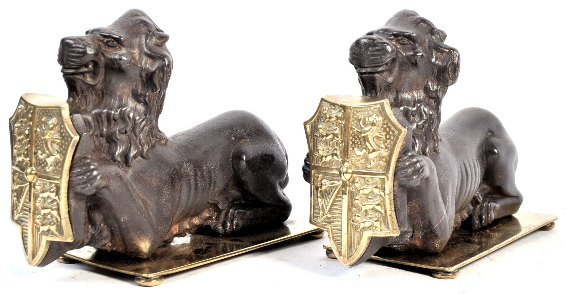 PAIR OF 19TH CENTURY CAST IRON FIRESIDE DOGS IN THE FROM OF LIONS